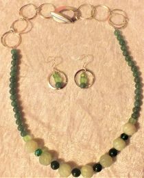 Many shades and textures of green glass with silver-tone chain and toggle clasp